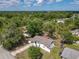 Overhead view of house highlighting the roof, landscaping, and the surrounding trees and neighborhood at 1113 Leeward Dr, Deltona, FL 32738