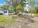 Spacious backyard featuring a gazebo, mature trees, grass, and a partial view of the home's exterior at 1113 Leeward Dr, Deltona, FL 32738