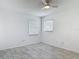 Cozy bedroom with natural light from two windows and modern tile floors at 1113 Leeward Dr, Deltona, FL 32738