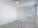 Light bedroom features tile floors, a ceiling fan, and a window at 1113 Leeward Dr, Deltona, FL 32738