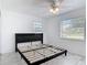 Modern bedroom with new gray tile flooring, ceiling fan, and lots of natural light at 1113 Leeward Dr, Deltona, FL 32738
