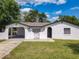 Charming single-story home with a stucco exterior, arched entryway, and attached carport at 1113 Leeward Dr, Deltona, FL 32738