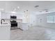 Beautiful all-white kitchen featuring stainless steel appliances and sleek countertops at 1113 Leeward Dr, Deltona, FL 32738