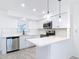Modern kitchen with stainless steel appliances, white cabinets, and peninsula island at 1113 Leeward Dr, Deltona, FL 32738
