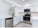 Updated kitchen with stainless steel appliances, white subway tile backsplash, and sleek countertops at 1113 Leeward Dr, Deltona, FL 32738