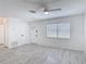 Bright, minimalist living room with new gray tile flooring and a large window at 1113 Leeward Dr, Deltona, FL 32738