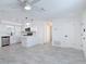 Bright, open-concept living space with new gray tile flooring and modern ceiling fan at 1113 Leeward Dr, Deltona, FL 32738