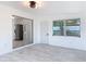 Spacious room with mirrored wall, modern floors, and view into kitchen at 1113 Leeward Dr, Deltona, FL 32738