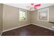 Bedroom with hardwood floors, a window, a ceiling fan with pink blades, and an air conditioning unit at 1121 Votaw Rd, Apopka, FL 32703