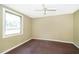 A bedroom features hardwood floors, complemented by a neutral-colored wall and natural light at 1121 Votaw Rd, Apopka, FL 32703