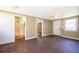The living room provides an open view to the bathroom, wood floors, and a ceiling fan at 1121 Votaw Rd, Apopka, FL 32703