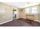 This light-filled room offers wood flooring, a vintage A/C unit, and transitions into the utility area at 1121 Votaw Rd, Apopka, FL 32703