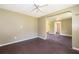 A cozy living area offering wood floors and walls, open to adjacent rooms, and filled with natural light at 1121 Votaw Rd, Apopka, FL 32703