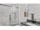 Updated bathroom with modern sliding glass shower doors, granite countertop, and contemporary fixtures at 11257 Dacre Ln, Orlando, FL 32824