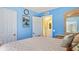Well-lit bedroom with a comfortable bed, large mirror and a doorway leading to the bathroom at 11257 Dacre Ln, Orlando, FL 32824
