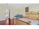 Bedroom featuring hardwood floors, a bed, and an arched doorway leading to an en-suite bathroom at 11257 Dacre Ln, Orlando, FL 32824