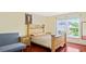 Tranquil bedroom with light wood furnishings, a window, and hardwood floors at 11257 Dacre Ln, Orlando, FL 32824