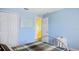 Cozy bedroom with a closet, blue walls, and a comfortable bed near a window at 11257 Dacre Ln, Orlando, FL 32824