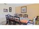 Formal dining room with seating for eight and decorative wall accents at 11257 Dacre Ln, Orlando, FL 32824