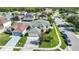 This home features a manicured front yard, mature landscaping, paver driveway and a bright red front door at 11257 Dacre Ln, Orlando, FL 32824