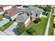 This home features a manicured front yard, mature landscaping, paver driveway and a bright red front door at 11257 Dacre Ln, Orlando, FL 32824