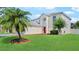 Charming two-story home features a well-manicured lawn, landscaping, and a bright red front door at 11257 Dacre Ln, Orlando, FL 32824
