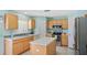 Bright kitchen with white tile flooring, stainless steel appliances, and center island at 11257 Dacre Ln, Orlando, FL 32824