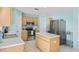 Bright kitchen with tile flooring, stainless steel appliances, and center island at 11257 Dacre Ln, Orlando, FL 32824