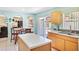 Bright kitchen with an island, stainless steel sink and appliances, and dining area at 11257 Dacre Ln, Orlando, FL 32824