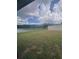 Tranquil backyard view with a serene lake, captured through a screen at 11373 Darlington Dr, Orlando, FL 32837