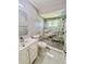 Bathroom features a shower with marble-like tiles, stone-look base, and a modern vanity at 11373 Darlington Dr, Orlando, FL 32837