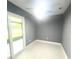 A bedroom with gray walls and sliding glass door at 11373 Darlington Dr, Orlando, FL 32837