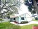 Charming single-story home with a well-manicured lawn and a light blue exterior at 11373 Darlington Dr, Orlando, FL 32837
