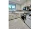 Modern kitchen features stainless steel appliances, quartz countertops and white cabinets at 11373 Darlington Dr, Orlando, FL 32837