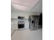 Bright kitchen featuring white cabinets, stainless steel appliances, and modern marble floors at 11373 Darlington Dr, Orlando, FL 32837