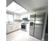 Bright kitchen with stainless steel appliances, white cabinets and marble flooring at 11373 Darlington Dr, Orlando, FL 32837