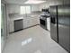 Bright kitchen featuring stainless steel appliances and white cabinetry and marble floors at 11373 Darlington Dr, Orlando, FL 32837