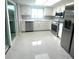 Well-lit kitchen featuring stainless steel appliances, and white cabinets, with bright tile flooring at 11373 Darlington Dr, Orlando, FL 32837