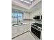 Bright kitchen features white cabinets, stainless steel appliances, and a window over the sink at 11373 Darlington Dr, Orlando, FL 32837