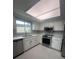 Bright kitchen features white cabinets and modern stainless steel appliances at 11373 Darlington Dr, Orlando, FL 32837