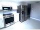 Modern kitchen with stainless steel appliances, a microwave, and gray walls at 11373 Darlington Dr, Orlando, FL 32837