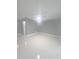 Spacious living room with modern gray walls, sleek white tile floor, and a ceiling fan at 11373 Darlington Dr, Orlando, FL 32837