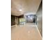 Large living room with tile flooring and doors leading to enclosed patio at 11373 Darlington Dr, Orlando, FL 32837
