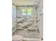 Newly remodeled shower with marble-style tiling and pebble floor at 11373 Darlington Dr, Orlando, FL 32837