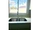 Stainless steel double sink with modern faucet and white countertops under large window at 11373 Darlington Dr, Orlando, FL 32837