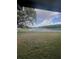 Screened view from inside the house, a scenic backyard with lake view and sky at 11373 Darlington Dr, Orlando, FL 32837