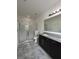 Bathroom with a glass-enclosed shower, granite countertop vanity, and neutral tile floor at 11464 Center Lake Dr, Windermere, FL 34786