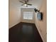 Cozy room features a ceiling fan, mounted TV, and window, complemented by hardwood flooring at 11464 Center Lake Dr, Windermere, FL 34786