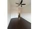 Bedroom featuring a ceiling fan, hardwood floors, bi-fold closet, and connecting bathroom at 11464 Center Lake Dr, Windermere, FL 34786