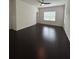 Spacious bedroom with dark wood floors, ceiling fan, and bright windows at 11464 Center Lake Dr, Windermere, FL 34786